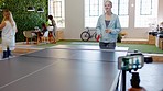 Table tennis, office and people playing a match in the break room while on lunch for fun. Team building, friendly competition and video recording on a phone of the game between employees for exercise