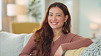 Happy, smile and face of woman on sofa laughing and cosy in living room at home. Portrait of young asian female enjoying peaceful and cheerful morning and free time to relax alone in apartment house 