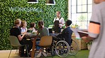 Workspace inclusion, meeting and creative team or web design collaboration diversity and equality for idea proposal. Disability, wheelchair and office men and women using laptop and tech for planning