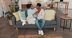 Phone, love and couple on social media news, post and online content together relax in home. Black woman online shopping show her man a sales offer, discount and deal on internet app with mobile tech