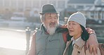 Senior asian couple, pointing or walking by Amsterdam city water port on holiday, vacation or retirement break. Talking elderly man or woman in love, trust bond or security in tourist travel location