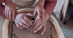 Love, pottery and hands of old couple molding in workshop studio for creative art, support and ceramics class. Trust, marriage and retirement with man and woman with clay wheel on crafting date