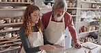 Art teacher, pottery and senior man in a class, learning tips in art class. Young woman teaching old man to roll clay, sculpture and giving instruction in studio to learn new skill in retirement