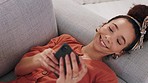 Black woman, phone and social media on living room sofa scroll, chat and typing internet texting message. Happy, laugh and smile on 5g smartphone social network mobile app reading sms on home couch