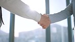 Handshake, partnership and trust in support, teamwork or deal together against a blurred background. Business people shaking hands in agreement, success and help in company b2b or meeting welcome