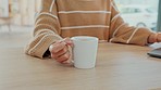 Hands, tea or coffee at laptop with woman on the internet working on research, report or studying. Home office, online and remote work employee holding warm drink on surface of work desk.

