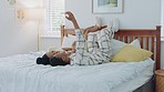 Selfie, kiss and African couple on a bed with a phone for communication on the internet in their house. Happy, young and black man and woman with photo and affection on a mobile while in the bedroom