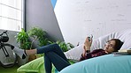 Creative, office and woman relax with smartphone on pillow for business social networking, reading chat app and typing email. Creativity tech design gen z girl with cellphone for social media update