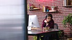 Woman, headphones and computer in office, writing ideas or planning strategy. Startup, business employee and female from Canada listening to music, podcast or radio while working on marketing brand.