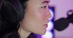 Radio, microphone and presenter talking on a podcast, blog or live stream in a neon room. Face of a young, Asian and creative woman speaking with headphones, doing a broadcast or live streaming