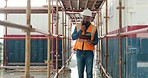 Hard hat, clipboard and black man for construction while walking, communication and speaking with walkie talkie. Architect, inspector and safety check talking, building inspection or engineer outdoor