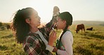 Cows, farm and mother bonding with child, fixing hair clip and standing on field. Farming, farm animals and mom with daughter in the morning enjoying sunrise in countryside showing love and affection