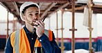 Logistics worker, walkie talkie and man on a construction site working on a building project. Architecture, communication and engineer talking on a radio while doing home maintenance or renovation.