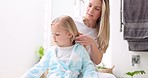 Girl, mother and brush hair in bathroom home, bonding and talking together. Love, hair care and support of mom grooming kid, helping or conversation and discussion while getting ready in the morning.