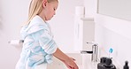 Cleaning, child and girl washing hands in the bathroom with soap for hygiene, healthcare and independence at home. Young, water and healthy kid doing sanitary routine at a sink for toxic bacteria