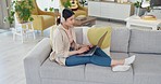 Woman student, study online with laptop and typing essay research report for university education. Elearning course, college assignment and listening to lecture on headphones on living room sofa home