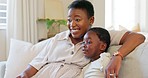 Relax, child and mother watching tv on the sofa in the living room of their house together. Excited, African and young kid with a cartoon, film or movie with their mom on the couch of their house