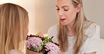 Flowers, gift and happy with mother and girl for mothers day, birthday or congratulations in family home. Gratitude, smile and love with child giving bouquet to mom for present and celebration
