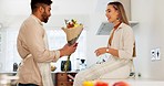 Couple love, flowers and happy cooking together in kitchen at home, romance and celebrate relationship bonding. Married man and woman smile, surprise bouquet and happiness care in family house