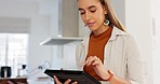 Tablet, search and remote work with a business woman doing research online while working from home. Internet, analytics and networking with a female entrepreneur or business owner in the kitchen