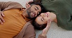 Kiss, love and couple on the floor of their living room to relax with happiness together in their house. Comic, happy and man and woman with smile for affection and funny conversation from above