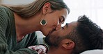 Couple, kiss or bonding on sofa in house living room or relax home in love, trust or security. Smile, happy and bonding interracial man or woman in intimate, romantic or support union on lounge couch