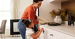 Mother, child and cooking together in home smelling of cookies after baking in oven of kitchen learning about food activity. Black woman and kid family happy about helping with lunch in UK house 