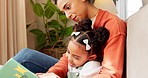 Mother, child and reading education, learning and teaching with story book for kids in the home living room. Latino woman and child read book, literature or story while relax, smile or happy together