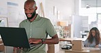 Laptop, creative and online order with a black man designer working in a workshop for shipping or delivery. Computer, ecommerce and logistics with a male managing stock or the shipment of goods