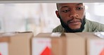 Logistics, inventory and small business man with boxes check stock on shelf for supply chain, ecommerce and distribution office management. Courier service worker search for cardboard package or mail