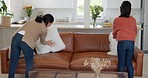 Asian family, mom and girl cleaning living room, house and sofa pillow in lounge. Housework, domestic life and daughter helping mother to clean, tidy and decorate couch and furniture in family home