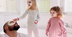 Family, father and girls in skincare mask, bonding and having fun in family home. Love, care and man with kids in clay mask or facial mask for healthy skin, glowing skin or beauty treatment in house.