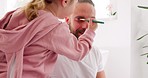 Family, makeup and girl with father in a bathroom, playing and bond while having fun with color, eyeshadow and beauty product. Happy family, skincare and kids being creative on parent face in Ukraine