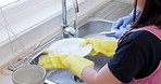 Children, learning and cleaning in a kitchen with girl washing dishes and bonding with sister in their home. Family, gloves and kids helping with housework, hygiene and bacteria prevention