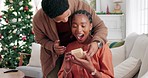 Wow, christmas and black couple with a surprise gift in celebration of a happy holiday in a lovey home together. Smile, happiness and African man giving an excited black woman a gift box present