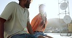 Summer, couple and rooftop date with happy, smile and relax woman and man talking, bonding and laughing. Love, sunset and interracial guy and lady enjoying the view of the city while flirting outdoor