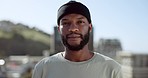 Face, confident and city with an edgy black man outdoor in an urban town for fashion or street style. Portrait, cityscape and lifestyle with a young African American male outside on a summer day