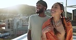 Travel, love and couple on a rooftop in the city of Rio De Janeiro, Brazil outdoors on a summer holiday vacation. Smile, romantic and happy woman enjoys an urban view on a terrace with a black man
