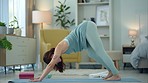 Exercise woman, yoga stretching and home fitness in living room floor for wellness, balance training and strong body. Healthy lady, pilates focus and flexible cobra workout training in house lounge
