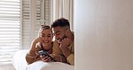 Relax, phone and couple in bed for social media, web and browsing in their home together, happy and smile. Love, planning and internet booking with interracial man and woman discuss plans in bedroom