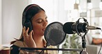 Woman, singer or musician in recording studio singing, acoustic and vocal audio production at home. Creative female artist or producer in music with headphones and microphone working on song or track