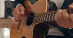 Hands, musician and playing acoustic guitar strumming strings in the studio at home. Hands of talented artist or professional guitarist with musical instrument producing music, audio or sound track