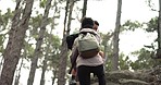 Help, hiking and couple climbing rock in Canada forest for day trekking, adventure and fitness. Support, helping and nature walk people climb for wellness, exercise and health challenge.

