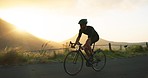 Fitness, man and cycling on road in mountain sports, exercise or workout during sunset in nature. Active male riding bicycle in the mountains for healthy cardio, training or outdoor cycle tour