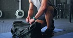 Gym bag, fitness and training coach about to start a workout and exercise on a mat. Sport athlete, man and strong cardio in a wellness, health and sports studio ready for exercising indoors