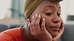 Black woman, tired and sad thinking of life stress at home while feeling anxiety, depression and fatigue. Mental health, frustrated and depressed African American lady on sofa of house in living room