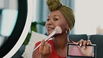 Makeup, live streaming and influencer black woman on smartphone for cosmetics review, social media advertising and blog. Video recording, living room studio and cellphone of woman with face tutorial