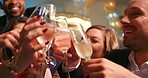 Young diverse friend group pouring alcohol holding glasses toasting at party