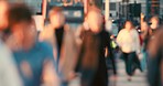 A crowd of people walking through the city