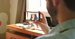 A man making a video call with his friend on his cellphone